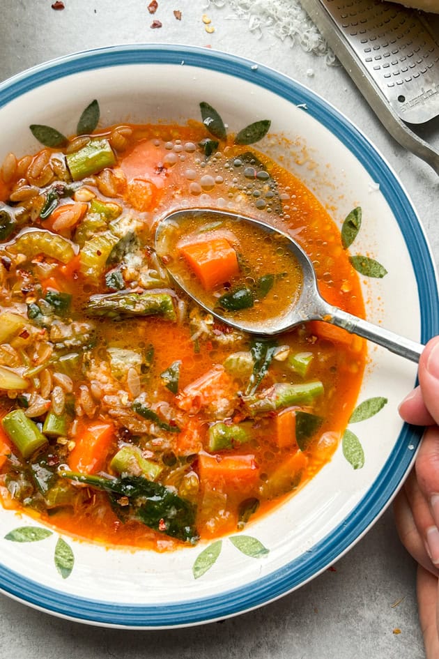 Easy Minestrone Soup with grated parmigiano reggiano cheese and chile flakes