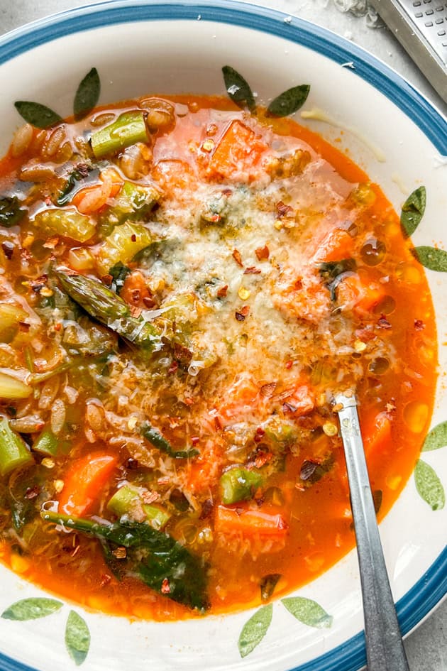 Easy Minestrone Soup with grated parmigiano reggiano cheese and chile flakes